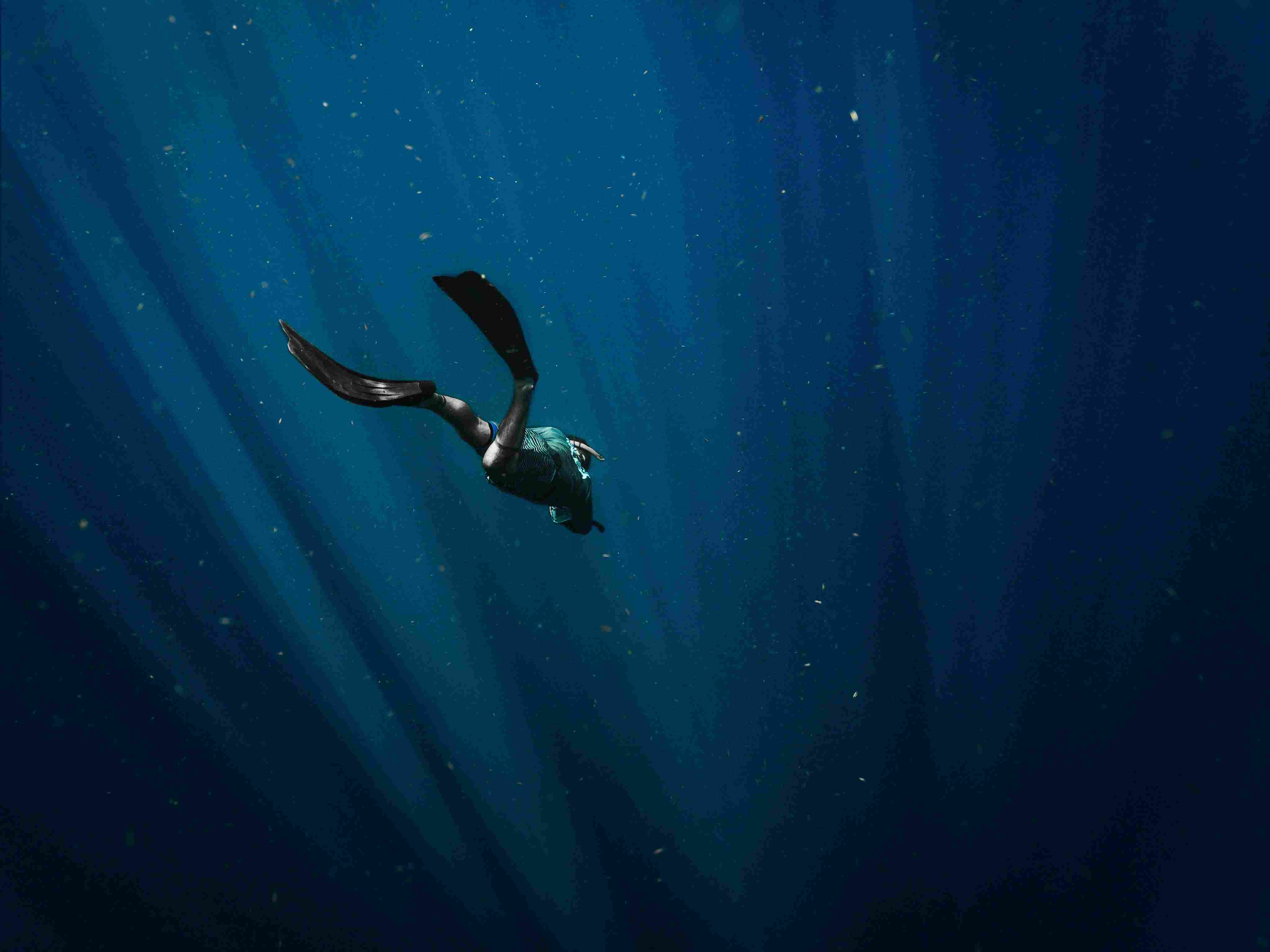 Diver entering tropical blue water